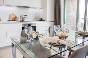 Apartments to Rent by Savills at Rehearsal Rooms, Ealing, W3, kitchen dining area